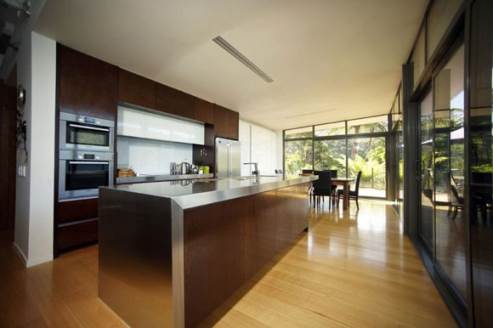 kitchen island with stainless steel countertop and dark wood 