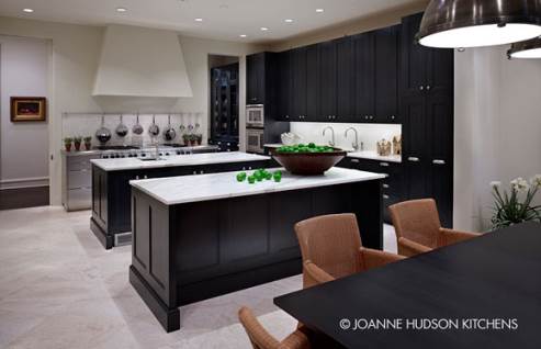 dark kitchen cabinets with white floors and countertop