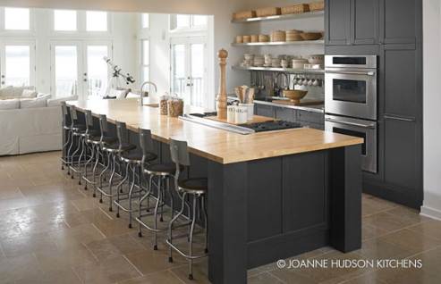 black kitchen with wooden countertop