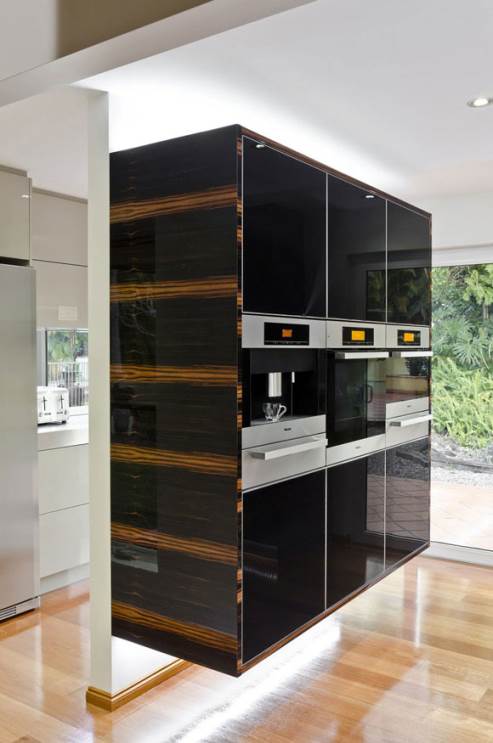 black cabinets and stainless steel Miele appliances